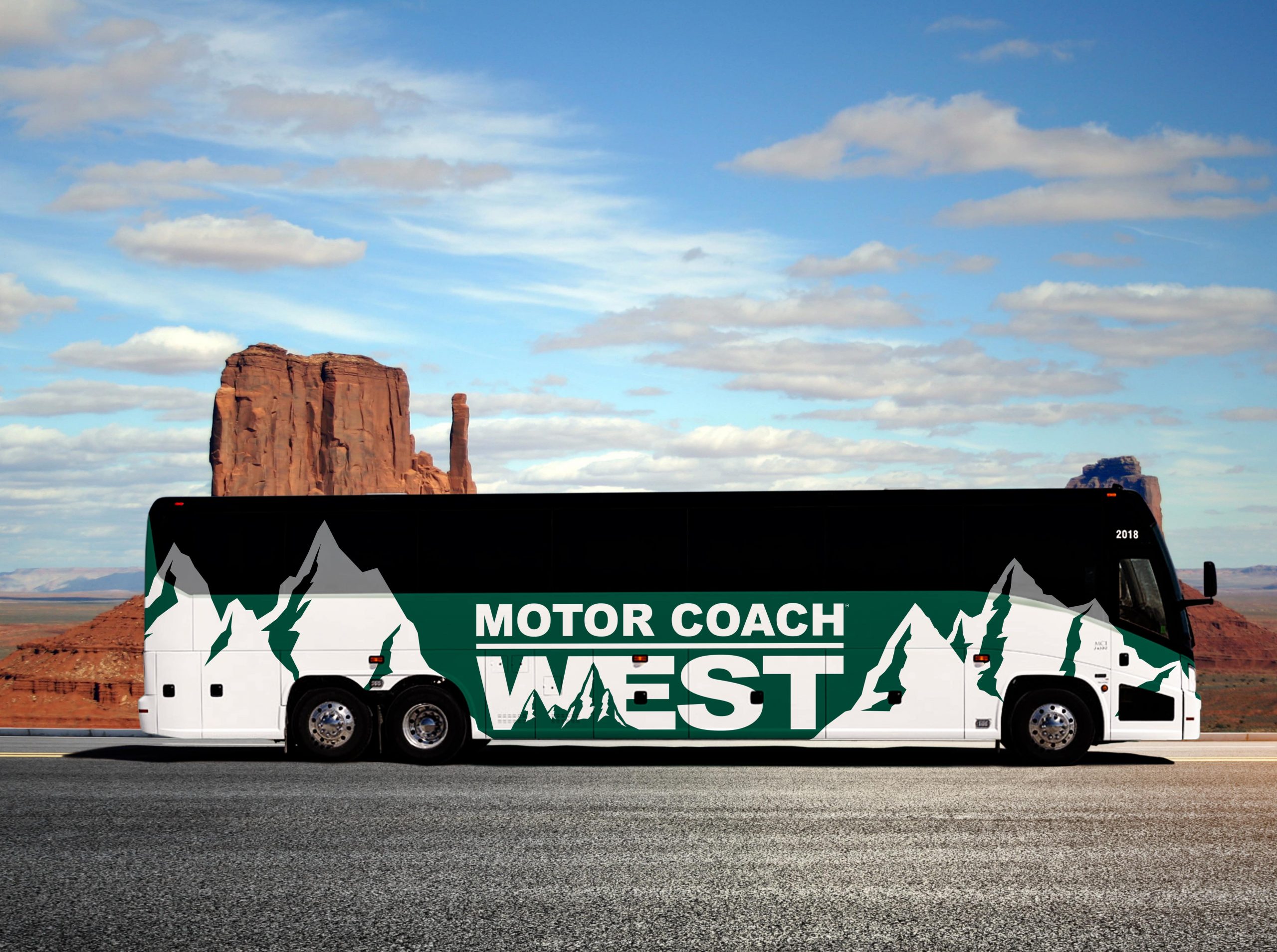 Green Motor Coach West bus against rock and cloudy sky background.