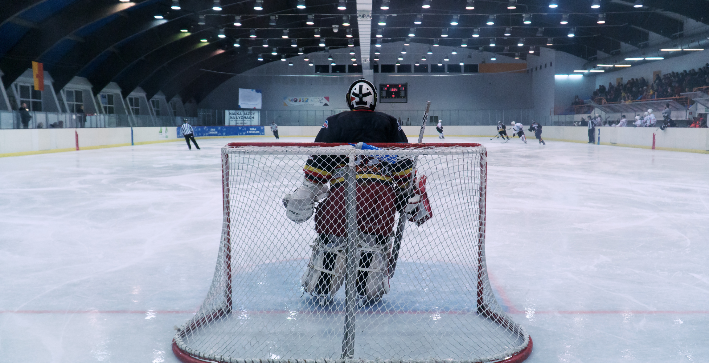 Players on ice rink playing ice hockey