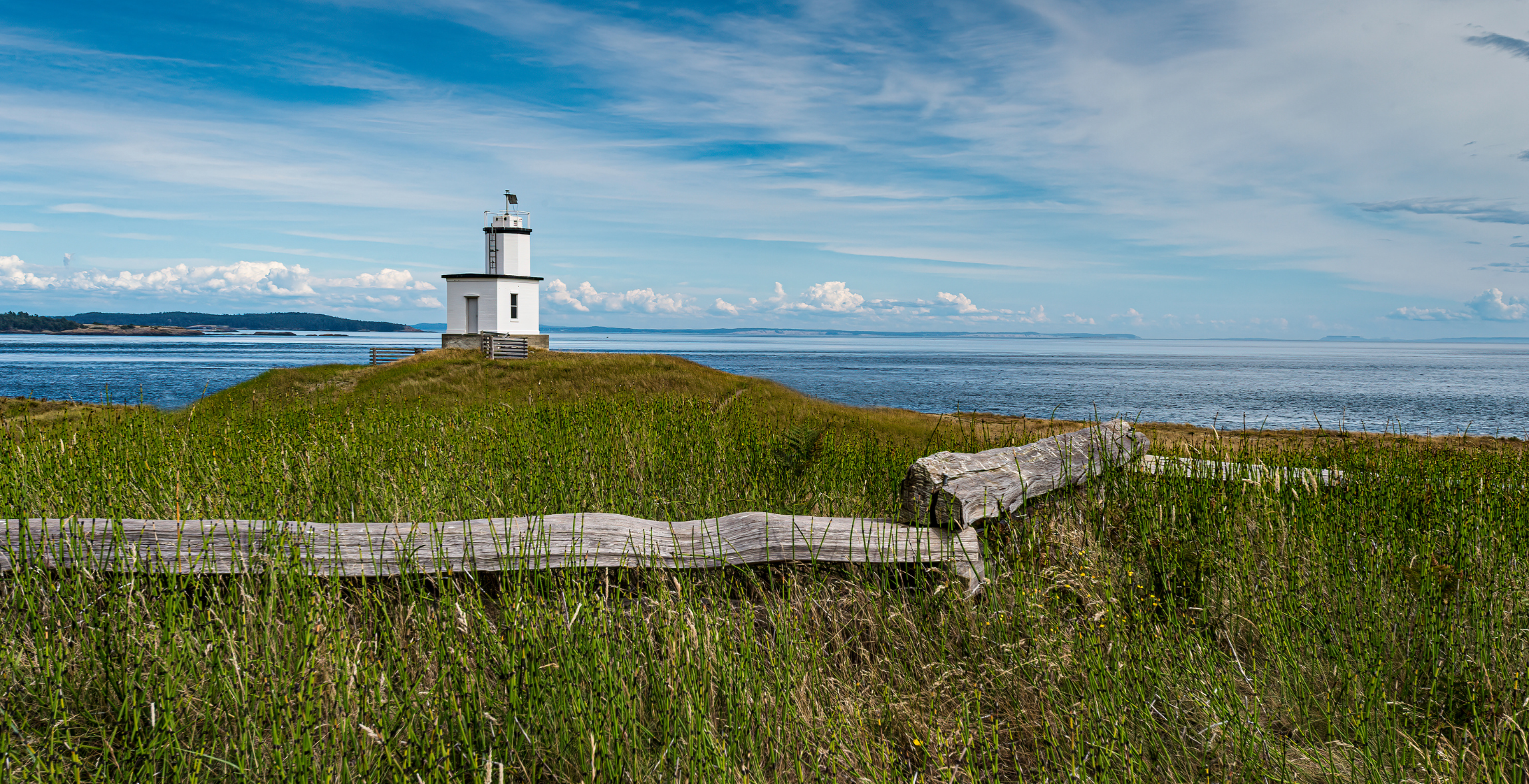 a lighthouse sits on a small hill in San Juan Island, Washington U.S