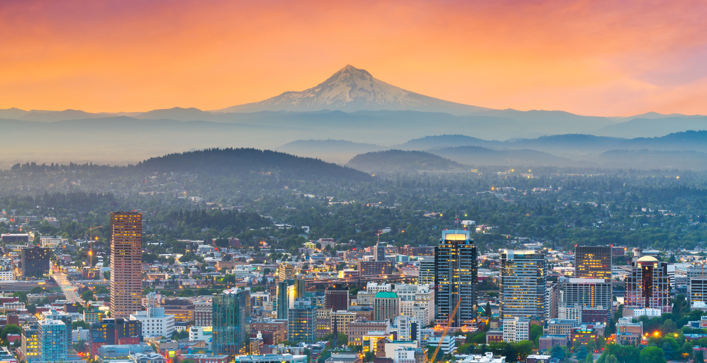  a view of Portland Oregon, with Mount Hood in the background