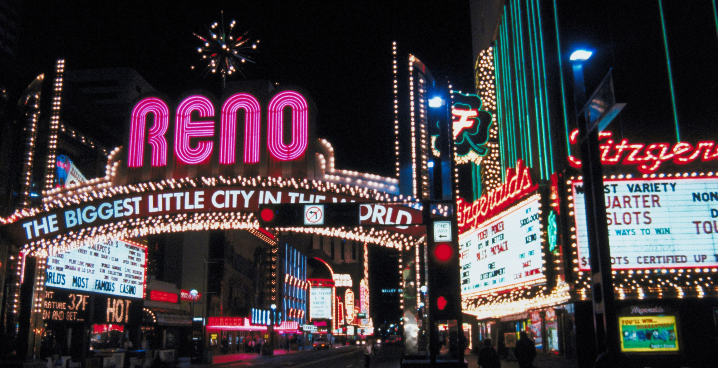 the city of Reno is lit up with signs at nighttime