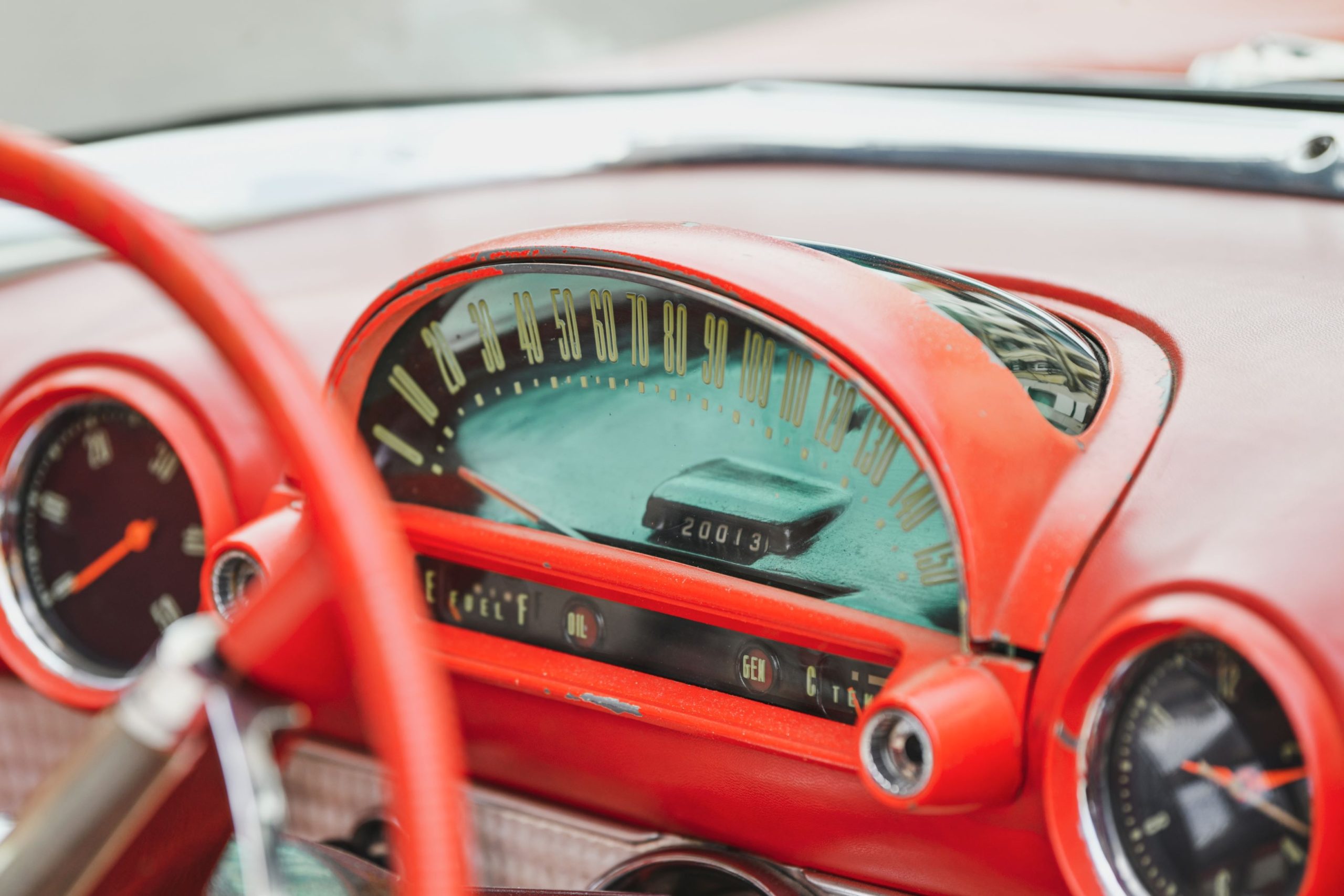 dashboard of a vintage car in red